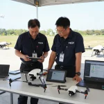 Technicians reviewing the terminatore dronavia drone safety system during an outdoor inspection.